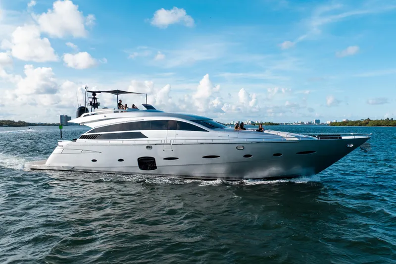 Slide: The Image of Luxury 2012 Pershing 92 yacht cruising on open water under a clear blue sky. - 3