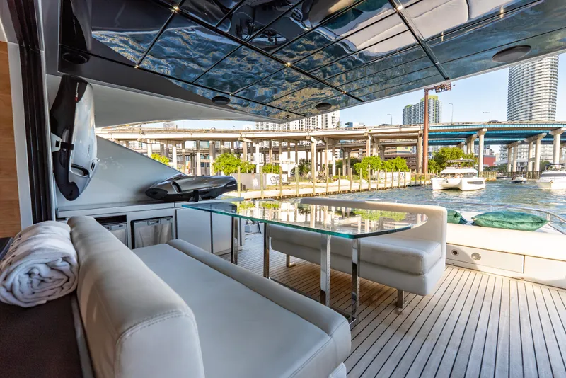 Slide: The Image of Luxurious 2012 Pershing 92 yacht deck with modern seating and waterfront city view. - 35