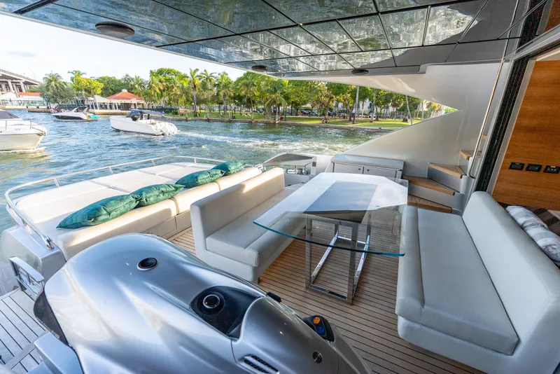 Slide: The Image of Luxurious 2012 Pershing 92 yacht deck with elegant seating and scenic waterfront view. - 36