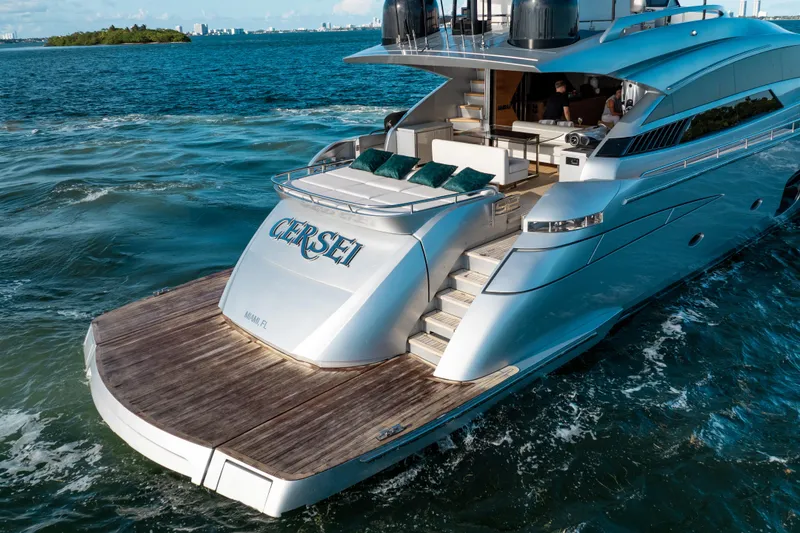 Slide: The Image of Luxurious 2012 Pershing 92 yacht cruising in Miami waters, featuring sleek design and spacious deck. - 9