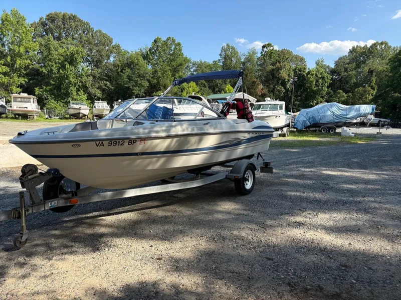 Slide: The Image of 2006 Maxum 1800 SR3 boat on trailer in a sunny outdoor storage area. - 1