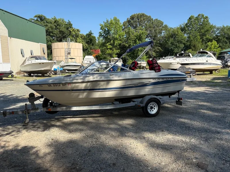 Slide: The Image of 2006 Maxum 1800 SR3 boat on trailer in outdoor storage area. - 2