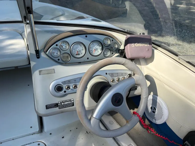 Slide: The Image of 2006 Maxum 1800 SR3 boat dashboard with steering wheel and Garmin GPS device. - 8