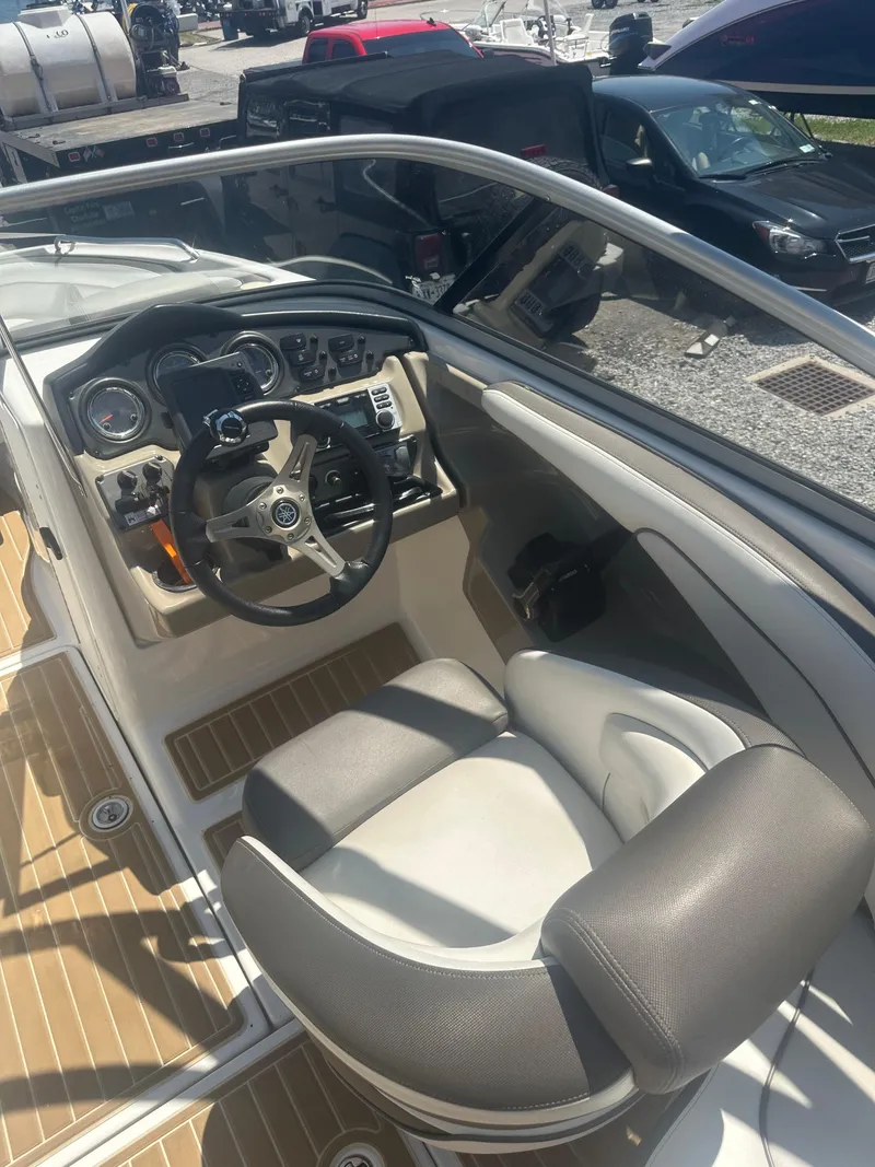 Slide: The Image of 2013 Yamaha Boats 242 Limited S cockpit with steering wheel and controls. - 15