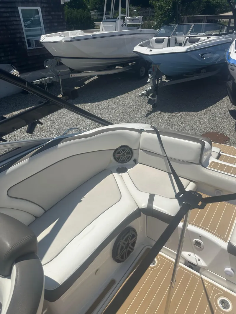 Slide: The Image of 2013 Yamaha Boats 242 Limited S interior with white seating and speaker detail. - 16