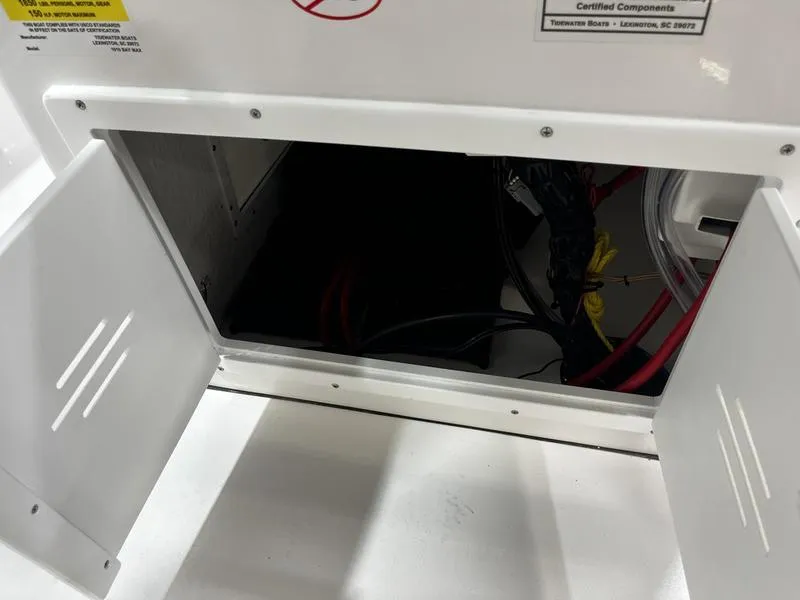 Slide: The Image of Open compartment on 2025 Tidewater 1910 Bay Max boat showing wiring and components. - 12