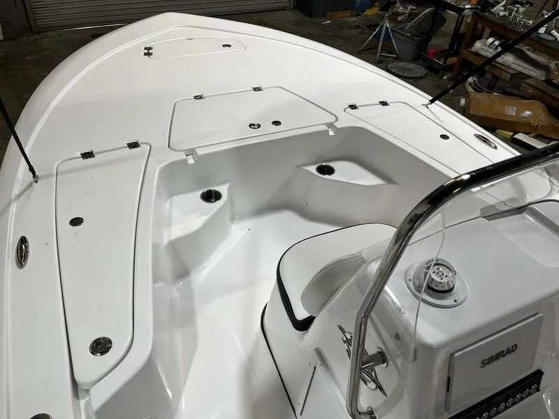 Slide: The Image of 2025 Tidewater 1910 Bay Max boat interior with white seating and storage compartments. - 13