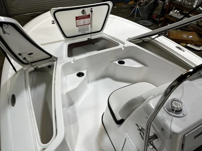 Slide: The Image of 2025 Tidewater 1910 Bay Max boat interior with open storage compartments. - 14
