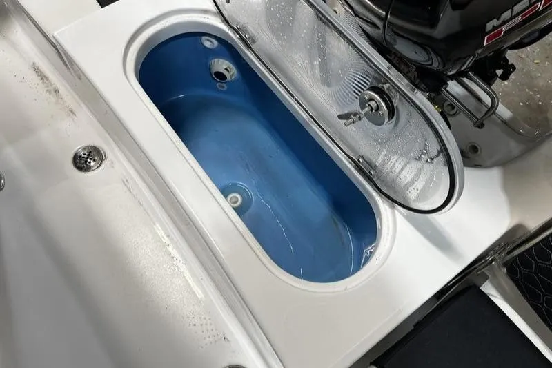 Slide: The Image of 2025 Tidewater 1910 Bay Max boat livewell with open lid, showcasing interior design. - 6