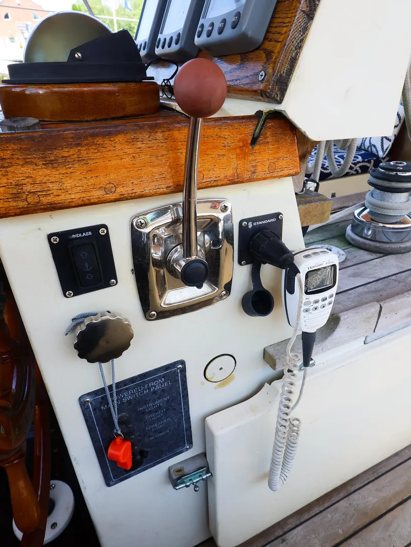 Slide: The Image of Control panel of a 1987 Gozzard 36 sailboat with throttle and communication devices. - 12