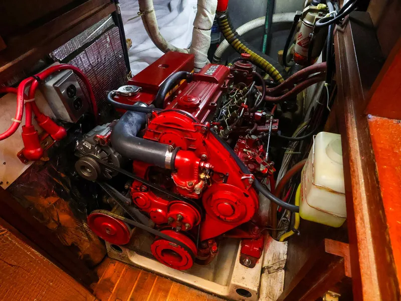 Slide: The Image of Engine compartment of a 1987 Gozzard 36 sailboat, featuring a red marine engine. - 19