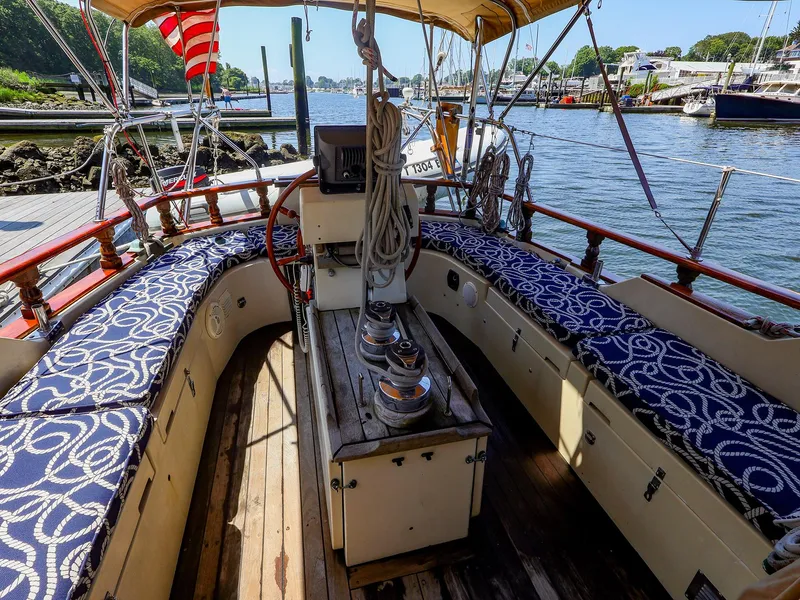 Slide: The Image of Interior view of a 1987 Gozzard 36 sailboat with patterned seating and nautical decor. - 21