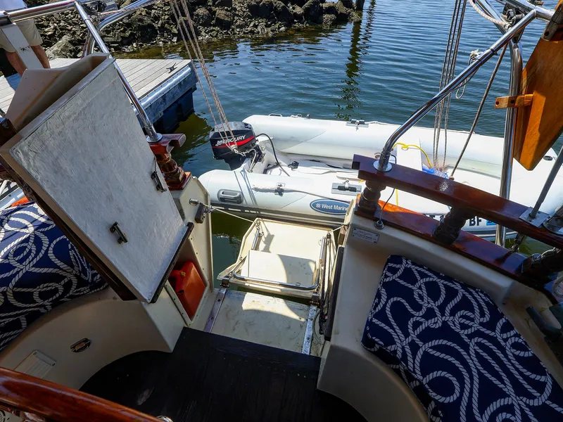 Slide: The Image of Gozzard 36 sailboat cockpit with nautical cushions and inflatable dinghy, 1987 model. - 29