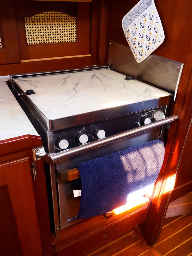 Slide: The Image of Stove and oven in 1987 Gozzard 36 yacht galley with wooden cabinetry. - 41