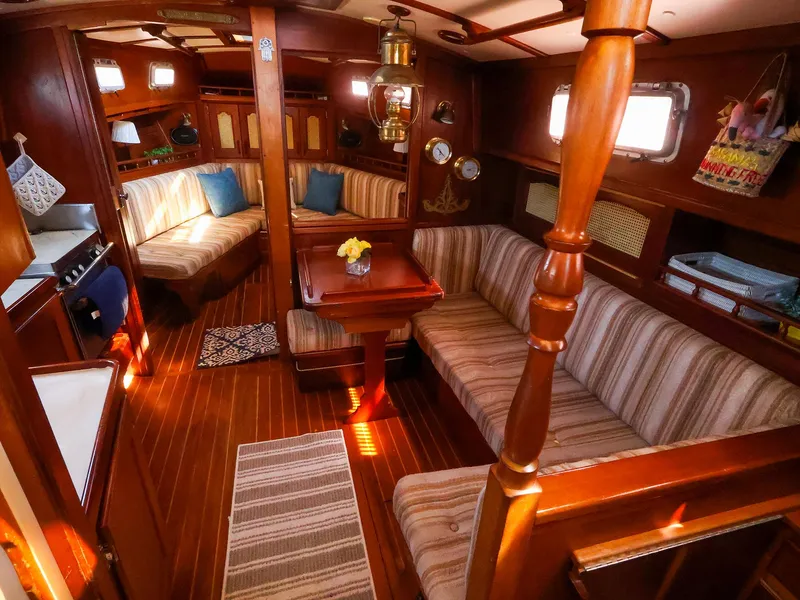 Slide: The Image of Interior of a 1987 Gozzard 36 sailboat with cozy seating and wooden finishes. - 42