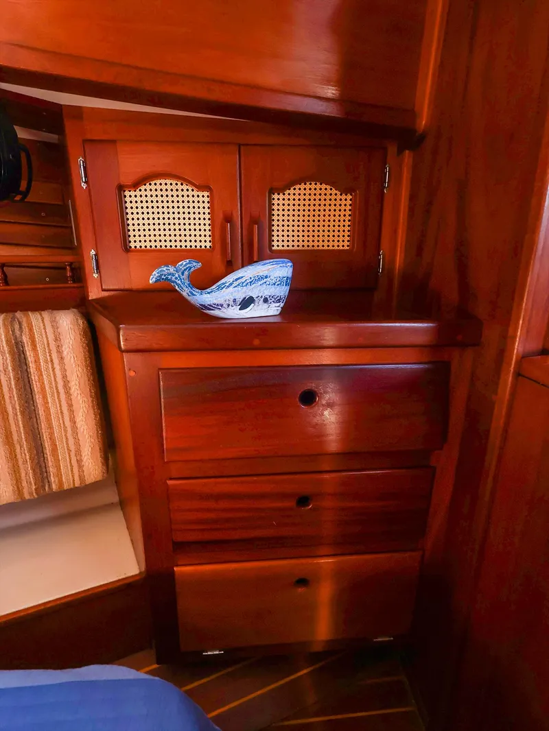 Slide: The Image of Wooden interior of 1987 Gozzard 36 sailboat with decorative whale figurine. - 46