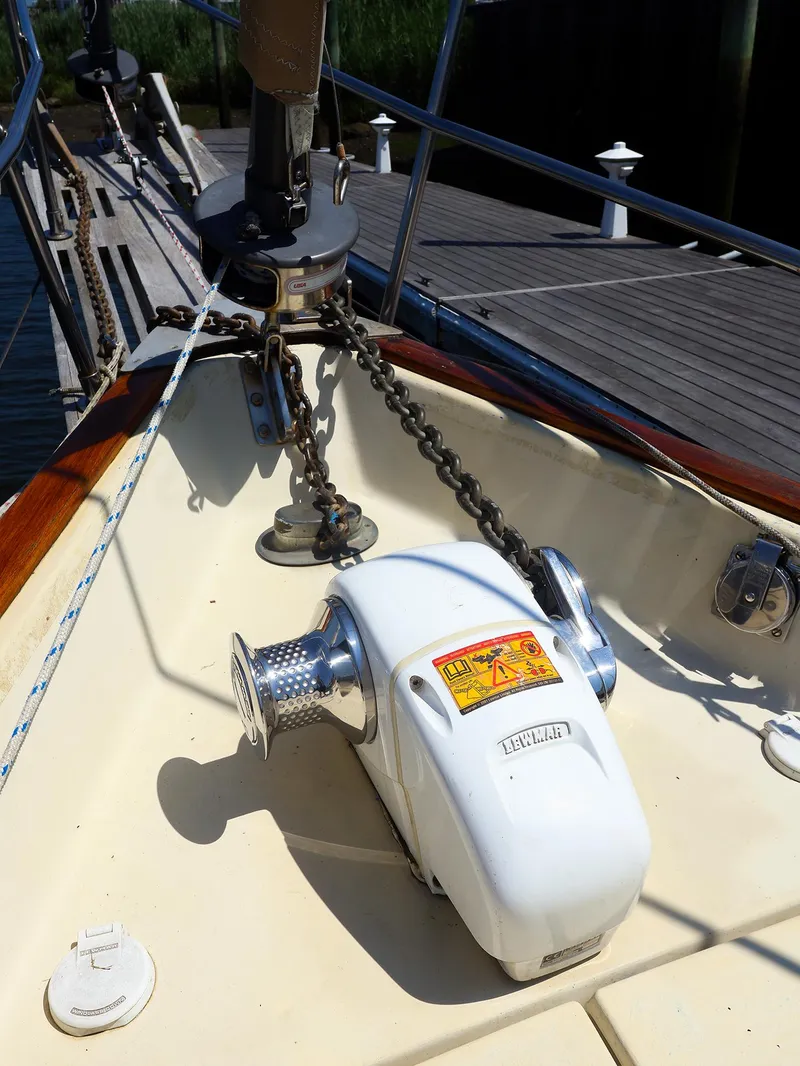 Slide: The Image of Anchor windlass on 1987 Gozzard 36 sailboat deck, near dock. - 8