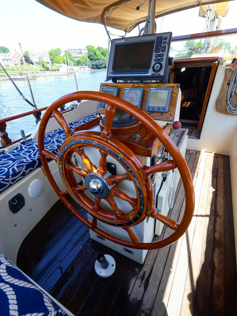 Slide: The Image of Wooden helm of a 1987 Gozzard 36 sailboat with navigation instruments. - 9