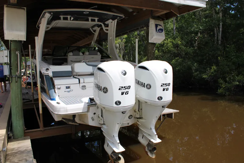 Slide: The Image of 2021 Chaparral 280 OSX boat with twin Yamaha 250 V6 engines docked in a marina. - 1