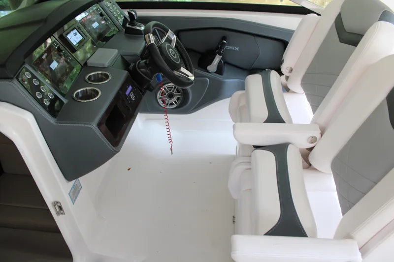 Slide: The Image of 2021 Chaparral 280 OSX boat interior with modern dashboard and dual seating. - 11