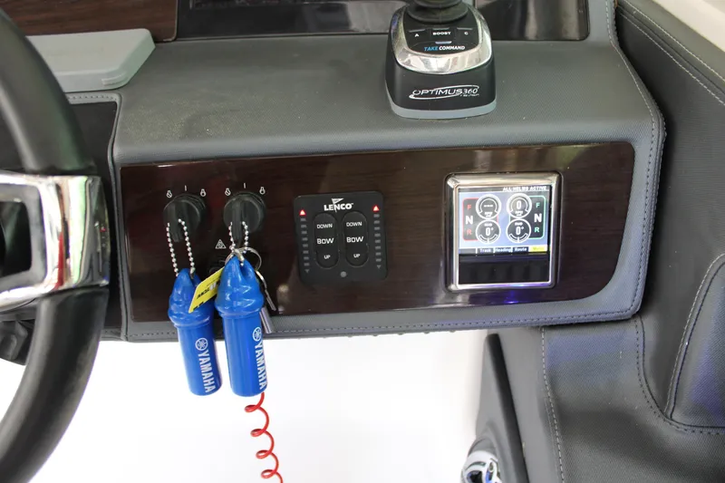 Slide: The Image of 2021 Chaparral 280 OSX dashboard with controls and Yamaha keys. - 22