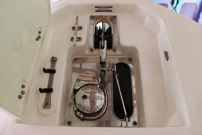 Slide: The Image of Anchor compartment of 2021 Chaparral 280 OSX boat with winch and tools. - 27