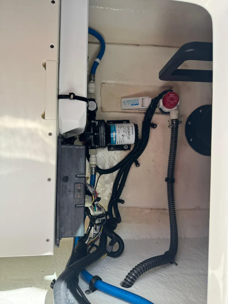 Slide: The Image of 2021 Chaparral 280 OSX boat interior wiring and pump system. - 38