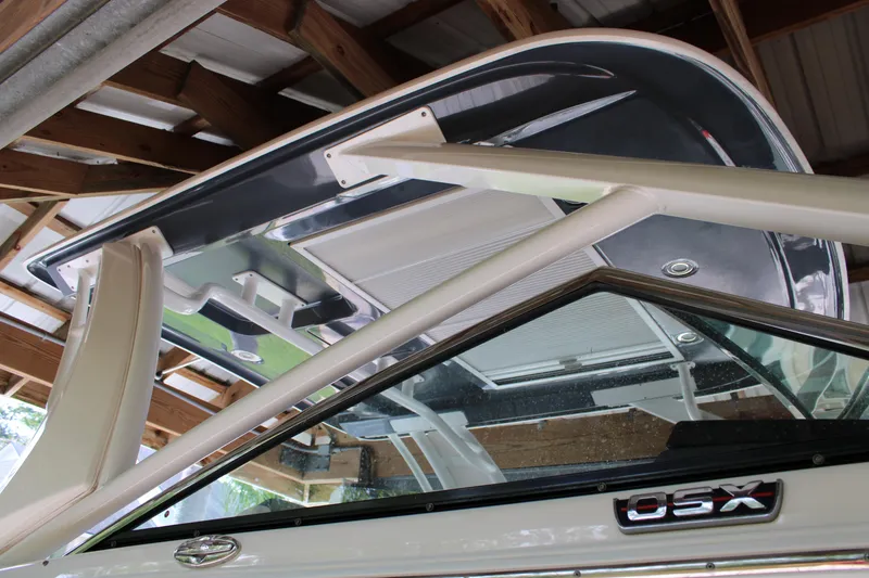 Slide: The Image of 2021 Chaparral 280 OSX boat under a wooden shelter, showcasing its sleek design. - 4