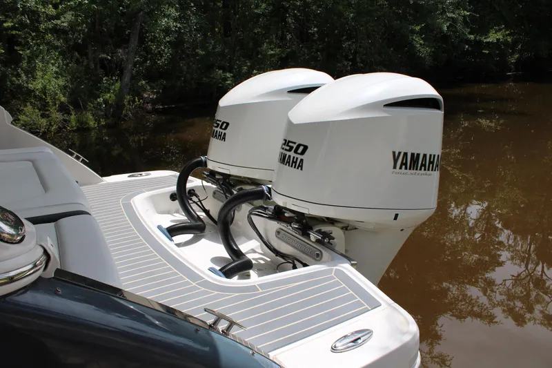 Slide: The Image of 2021 Chaparral 280 OSX boat with dual Yamaha 250 engines on a calm river. - 6