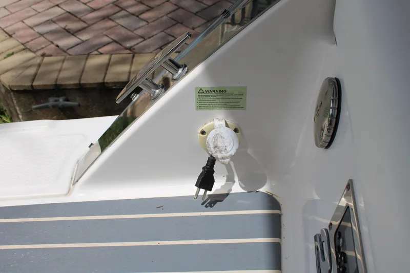 Slide: The Image of 2021 Chaparral 280 OSX boat deck with power outlet and warning label. - 8