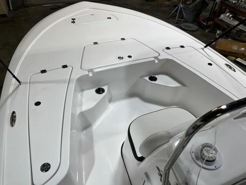 Slide: The Image of 2025 Tidewater 1910 Bay Max boat interior with storage compartments and seating. - 11