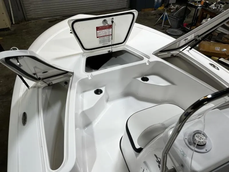 Slide: The Image of 2025 Tidewater 1910 Bay Max boat interior with open storage compartments. - 12