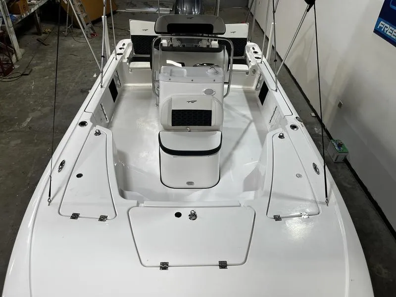 Slide: The Image of 2025 Tidewater 1910 Bay Max boat interior, featuring sleek white design and modern controls. - 13