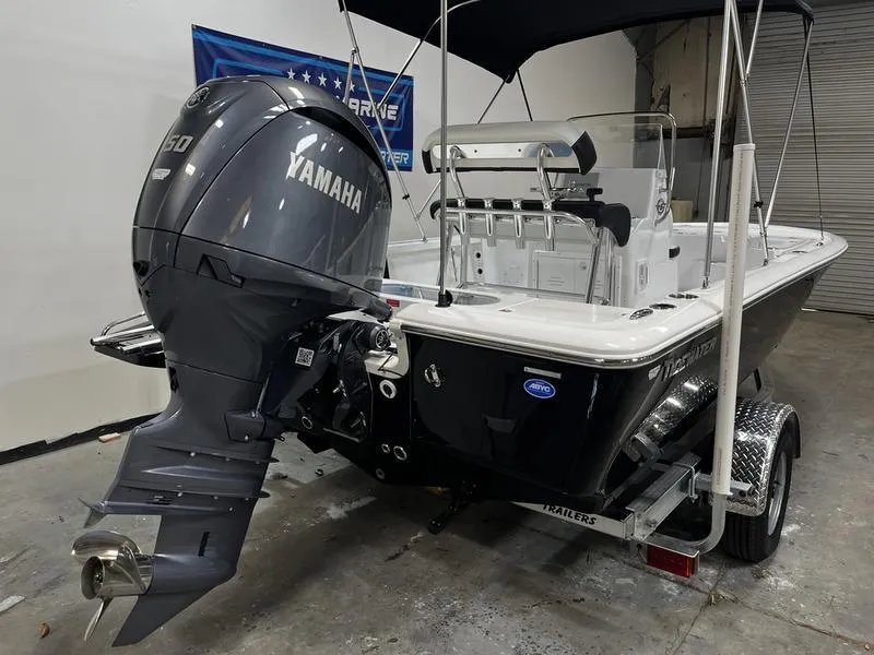 Slide: The Image of 2025 Tidewater 1910 Bay Max boat with Yamaha engine on trailer in garage. - 3