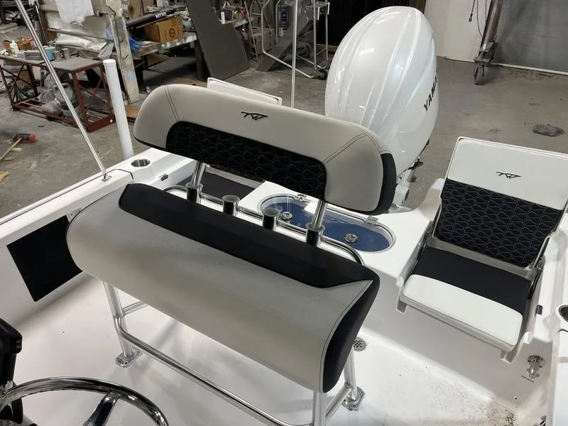 Slide: The Image of 2025 Tidewater 1910 Bay Max boat interior with seating and Yamaha engine. - 4