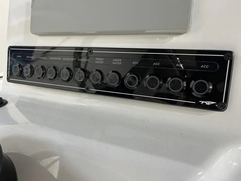 Slide: The Image of Control panel of 2025 Tidewater 1910 Bay Max boat with labeled switches. - 8