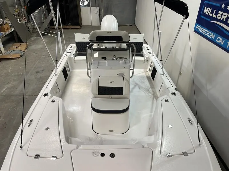 Slide: The Image of 2025 Tidewater 1910 Bay Max boat interior with seating and console in showroom. - 9