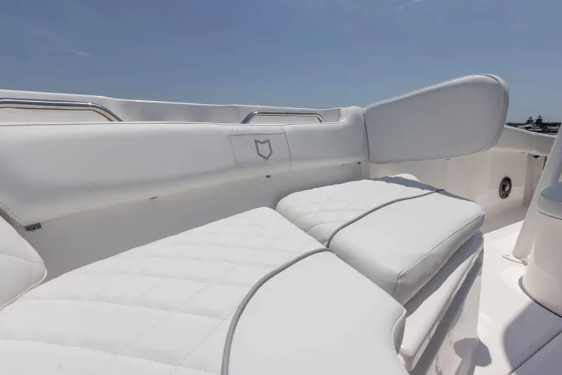 Slide: The Image of Manufacturer Provided Image: 2025 Sea Fox 228 Commander boat with white cushioned seating under clear sky. - 9