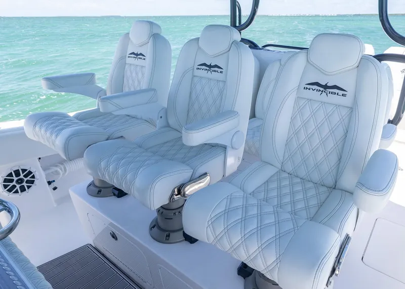 Slide: The Image of Luxurious seating on 2025 Invincible 43 Open Fisherman boat with ocean backdrop. - 20