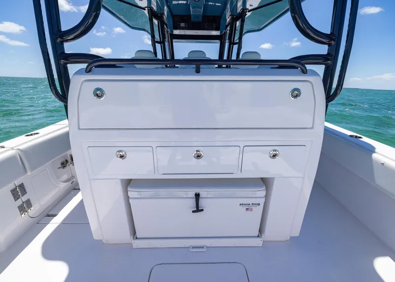 Slide: The Image of 2025 Invincible 43 Open Fisherman boat interior with storage and cooler on open sea. - 22