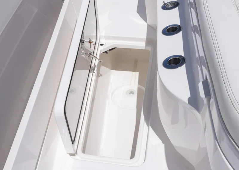Slide: The Image of 2025 Invincible 43 Open Fisherman boat storage compartment with rod holders. - 36