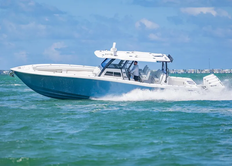 Slide: The Image of 2025 Invincible 43 Open Fisherman cruising on open water under blue skies. - 44