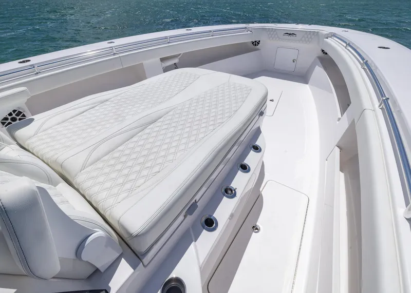 Slide: The Image of 2025 Invincible 43 Open Fisherman boat with luxurious white seating and ocean backdrop. - 7