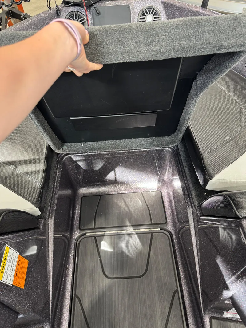 Slide: The Image of 2025 Skeeter Solera 189 boat interior with storage compartment open. - 17