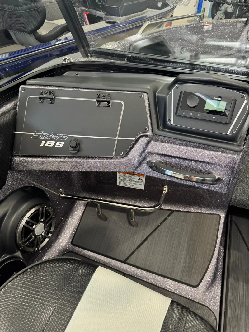Slide: The Image of 2025 Skeeter Solera 189 boat dashboard with control panel and speaker. - 23