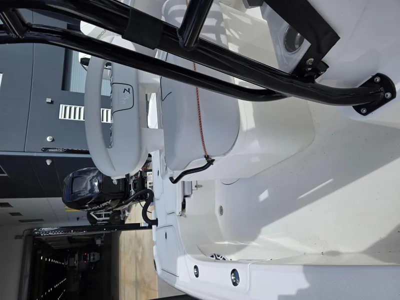 Slide: The Image of 2023 SeaVee 270Z boat interior with seating and equipment in a garage setting. - 7