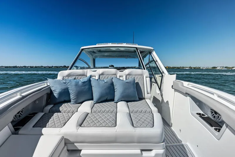 Slide: The Image of 2026 Everglades 367 CX boat interior with white seating and elegant design. - 13