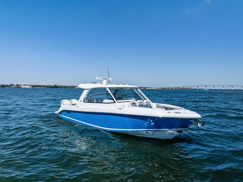 Slide: The Image of 2026 Everglades 367 CX boat cruising on open water, showcasing sleek design and performance. - 2