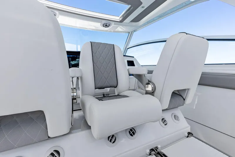 Slide: The Image of 2026 Everglades 367 CX boat interior with seating, on a sunny day at sea. - 22