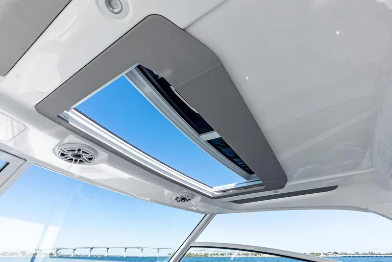 Slide: The Image of Interior view of 2026 Everglades 367 CX boat with open sunroof and speakers. - 27